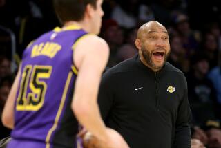 Los Angeles, CA - Coach Darvin Ham directs the Lakers from the sidelines during a game.