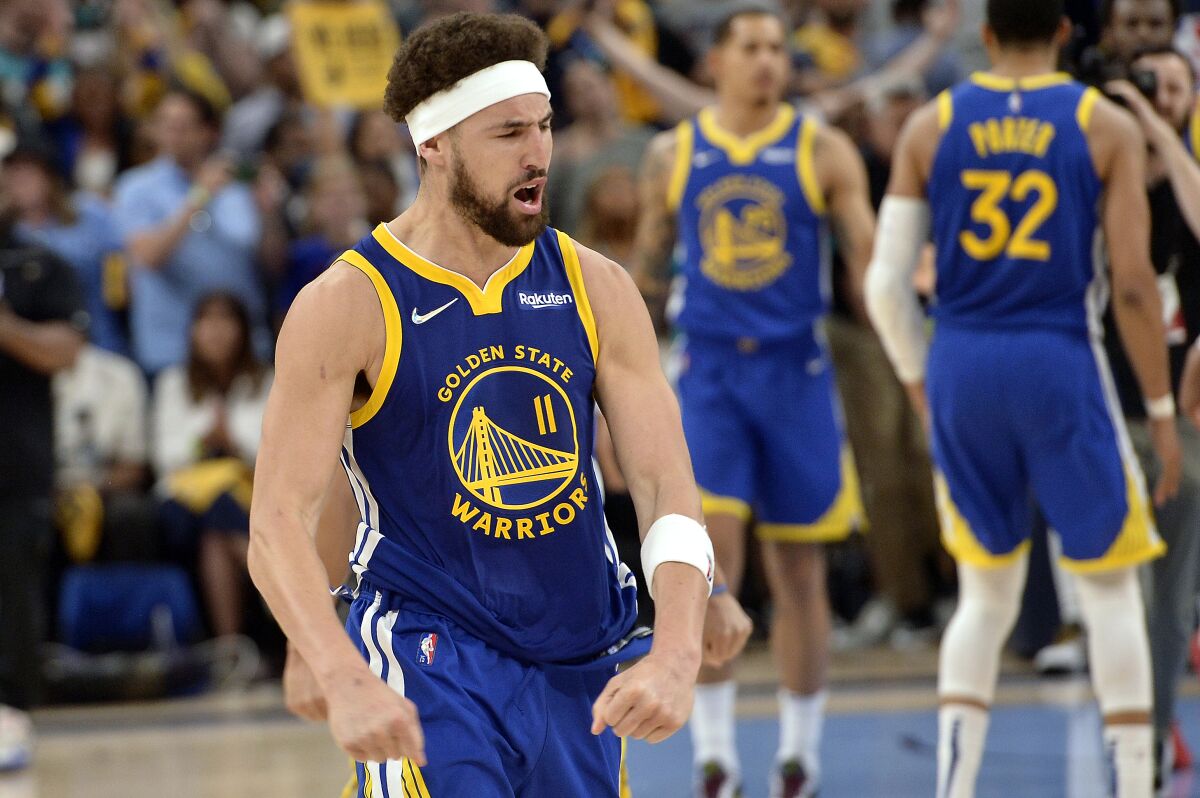 Golden State Warriors guard Klay Thompson (11) reacts after a win over the Memphis Grizzlies during Game 1 of a second-round NBA basketball playoff series Sunday, May 1, 2022, in Memphis, Tenn. (AP Photo/Brandon Dill)