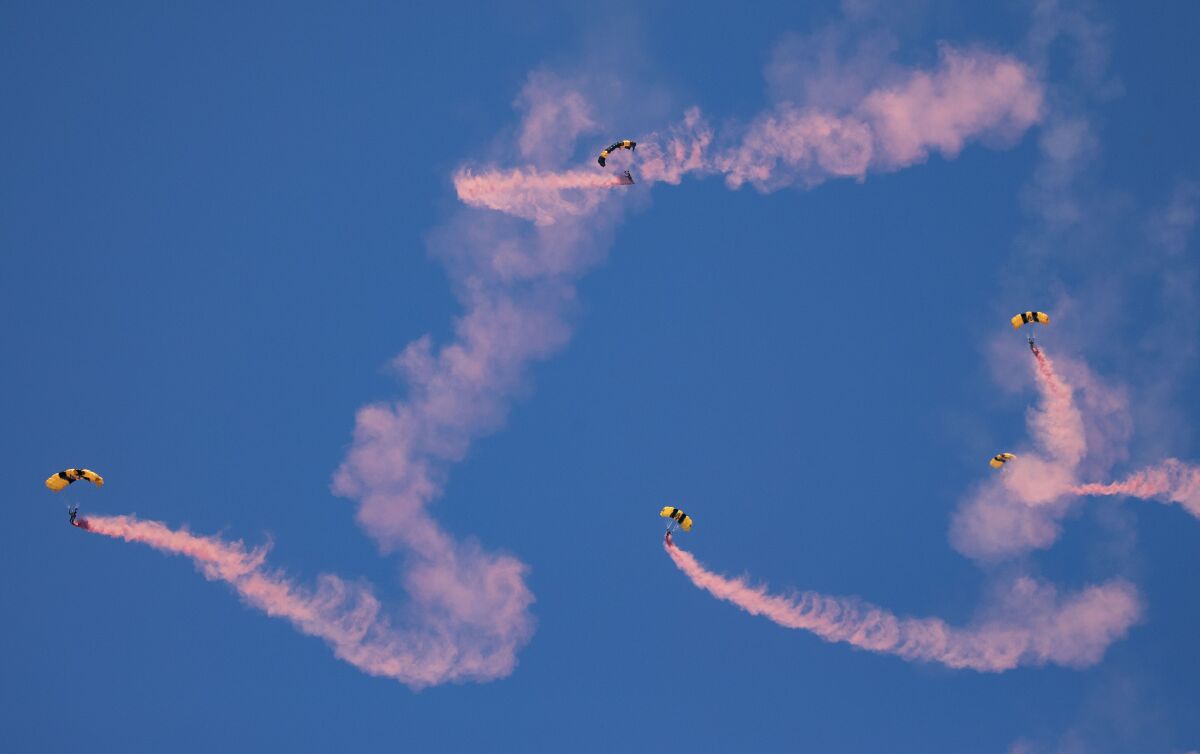  Members of the U.S. Army Golden Knights Parachute Demonstration Team jump.