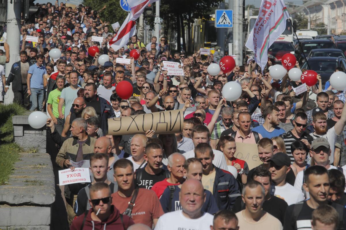 Workers with posters reading "Go away!" march against Belarusian President Alexander Lukashenko in Minsk on Monday. 