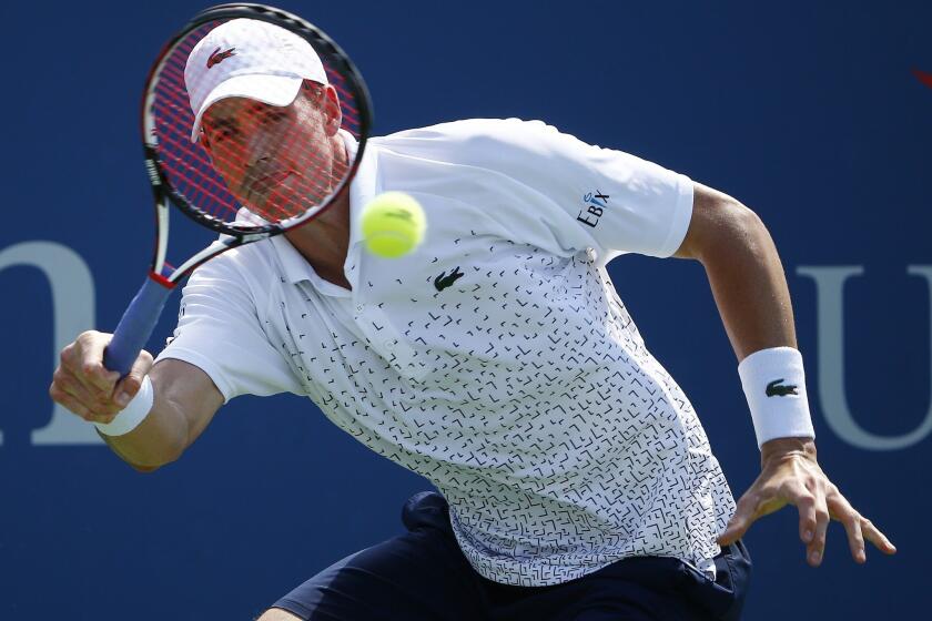 John Isner hits a return to Jan-Lennard Struff of Germany during a match at the U.S. Open on Thursday. Isner defeated Struff, 7-6, 6-4, 6-2.