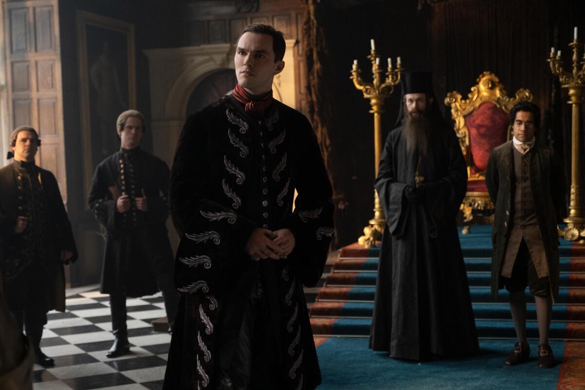 Nicholas Hoult, center, as Peter II of Russia, with Adam Godley as the Archbishop and Sacha Dhawan as Count Orlo in the Hulu historical comedy "The Great."