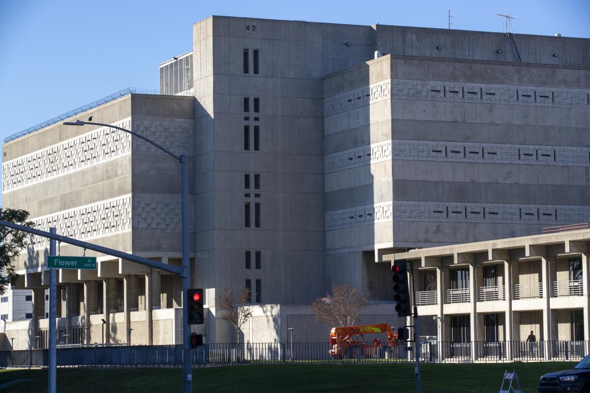 A pedestrian walks past the Orange County Jail and Orange County Sheriff's Department Headquarters