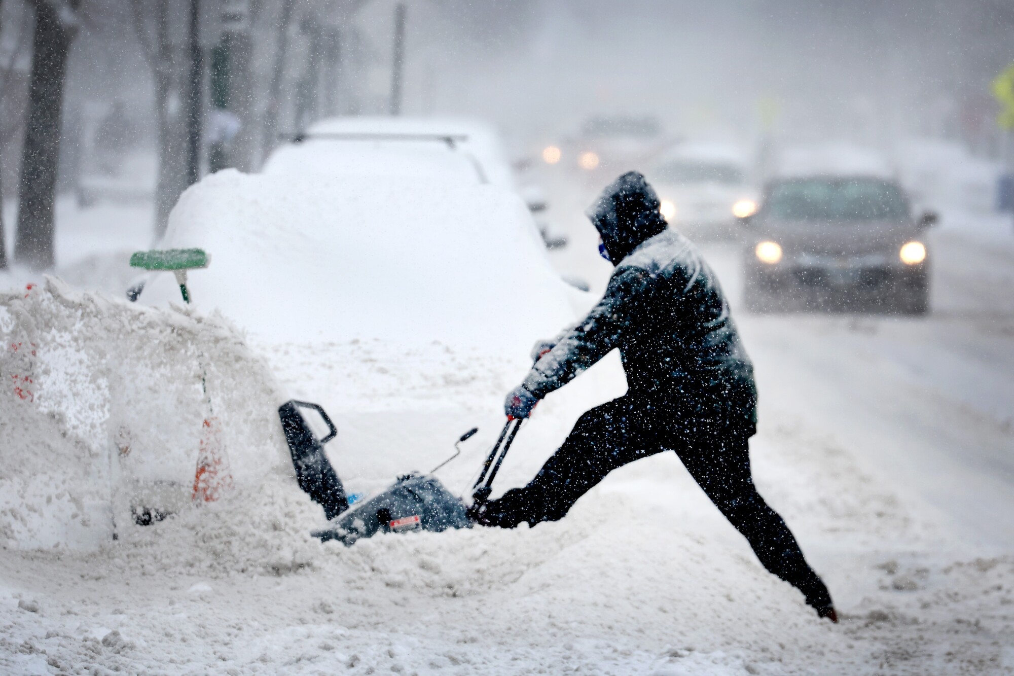 A resident digs out his car on February 02, 2022 in Chicago, Illinois.