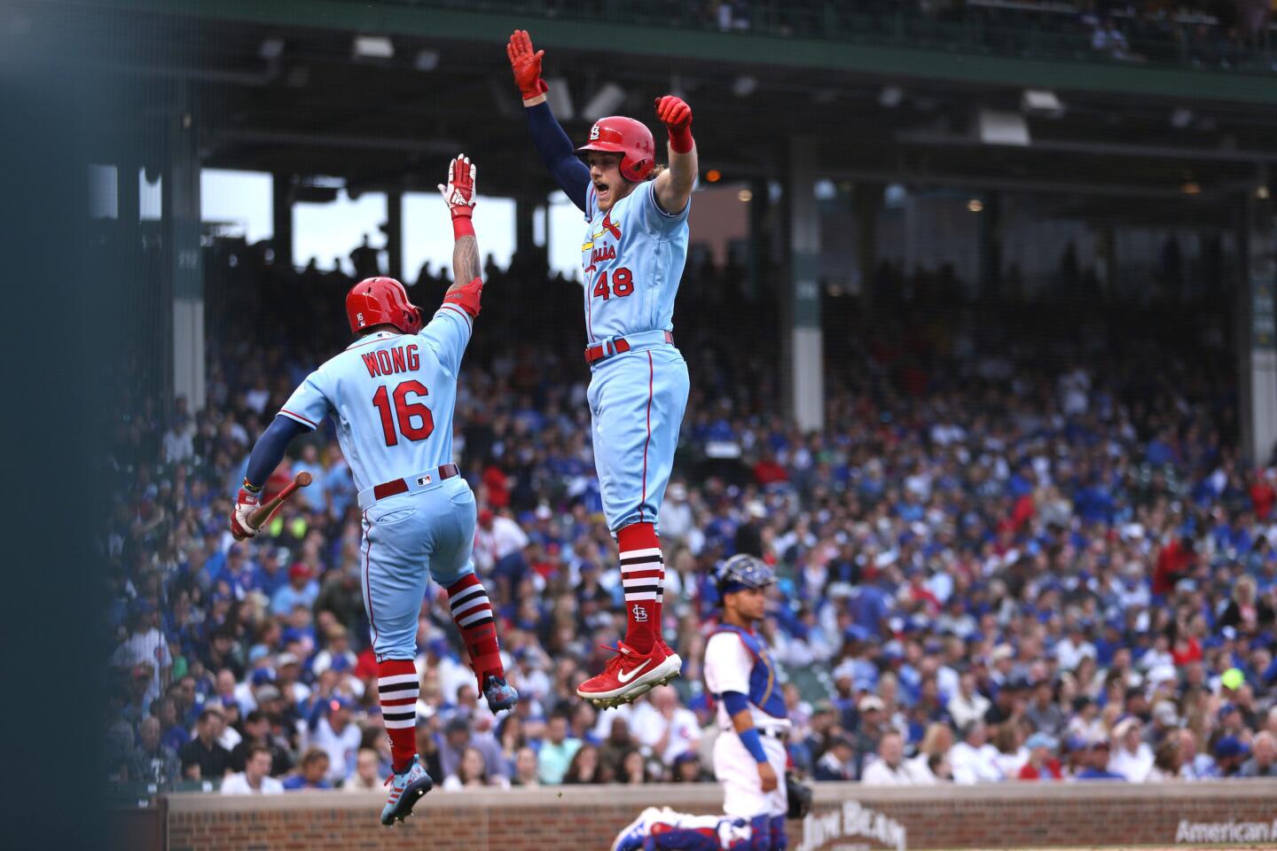 St. Louis Cardinals batter Harrison Bader celebrates with teammate Kolten Wong after Bader hit a solo homer off of Chicago Cubs starting pitcher Jon Lester in the first inning of a game at Wrigley Field in Chicago on June 8, 2019.
