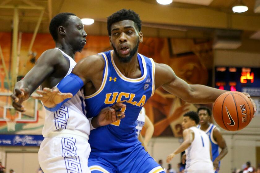 LAHAINA, HI - NOVEMBER 26: Cody Riley #2 of the UCLA Bruins and Bill Awet #12 of the Chaminade Silverswords do battle in the paint during the second half at the Lahaina Civic Center on November 26, 2019 in Lahaina, Hawaii. (Photo by Darryl Oumi/Getty Images)