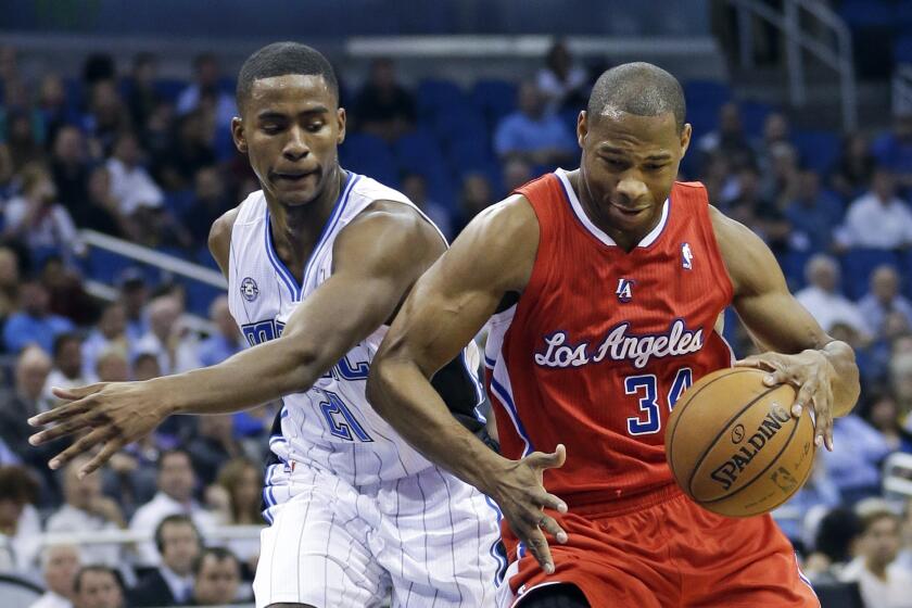 Clippers guard Willie Green, right, tries to drive past Orlando's Maurice Harkless.