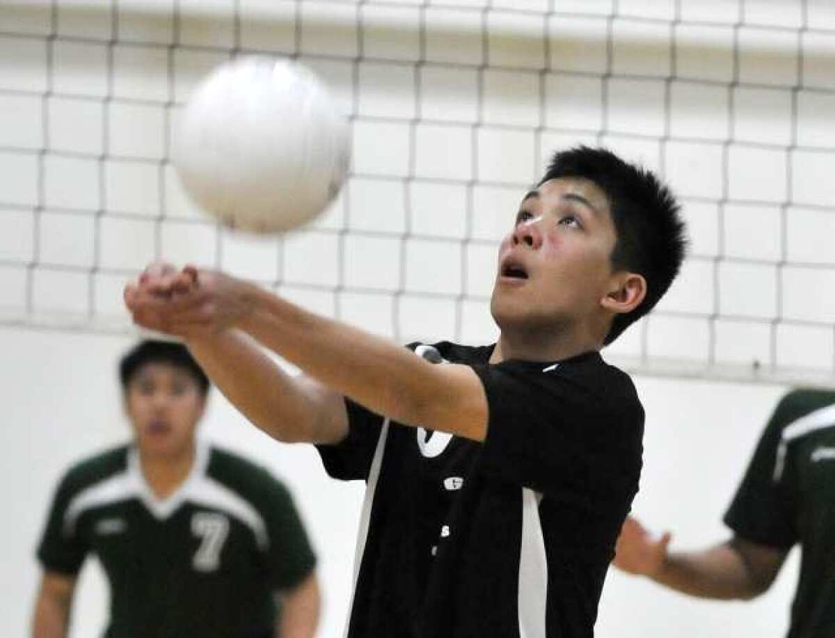 Glendale Adventist Academy's Justin Ng bumps the ball against Providence in a Liberty League boys' volleyball match at Glendale Adventist Academy in Glendale on Wednesday, March 27, 2013.
