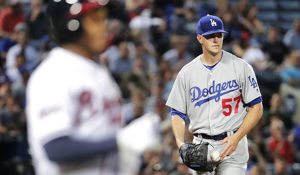 Dodgers starting pitcher Alex Wood, right, stands on the mound after walking Atlanta Braves' Mallex Smith, left, with the bases loaded to score Jeff Francoeur during the third inning on Tuesday.