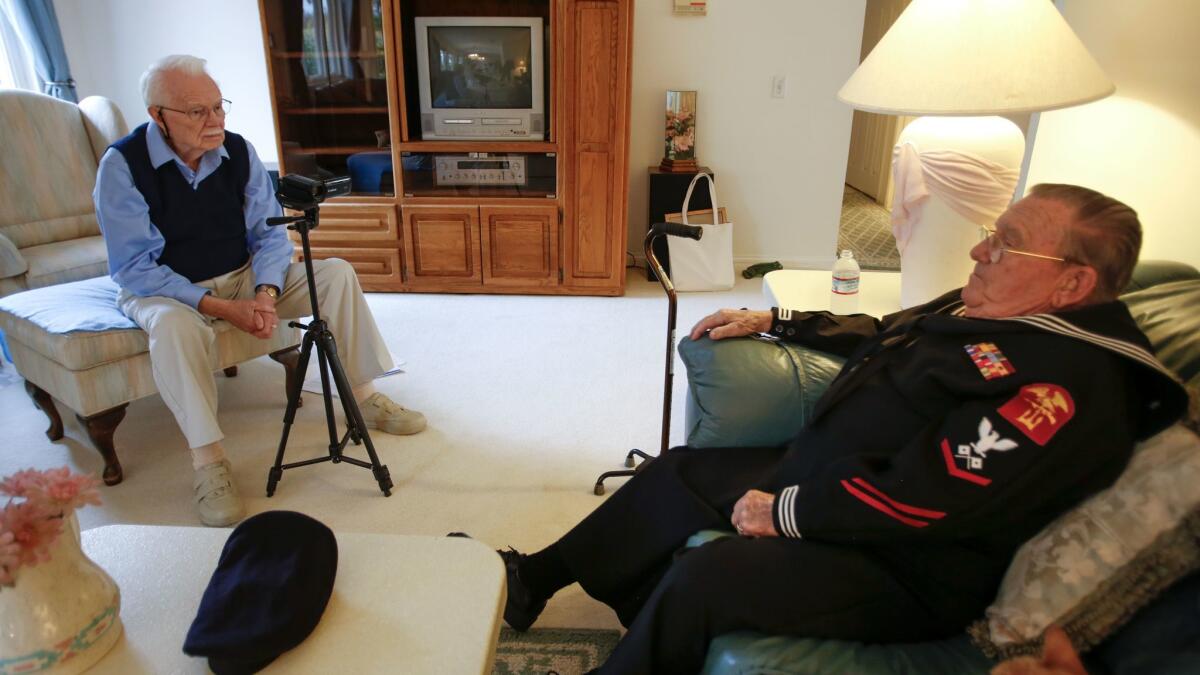 In the living room of his home in Rancho Bernardo, Stan Smith, 89, interviews World War II veteran Gilbert Nadeau, 90, of Escondido for the Veteran History Project.
