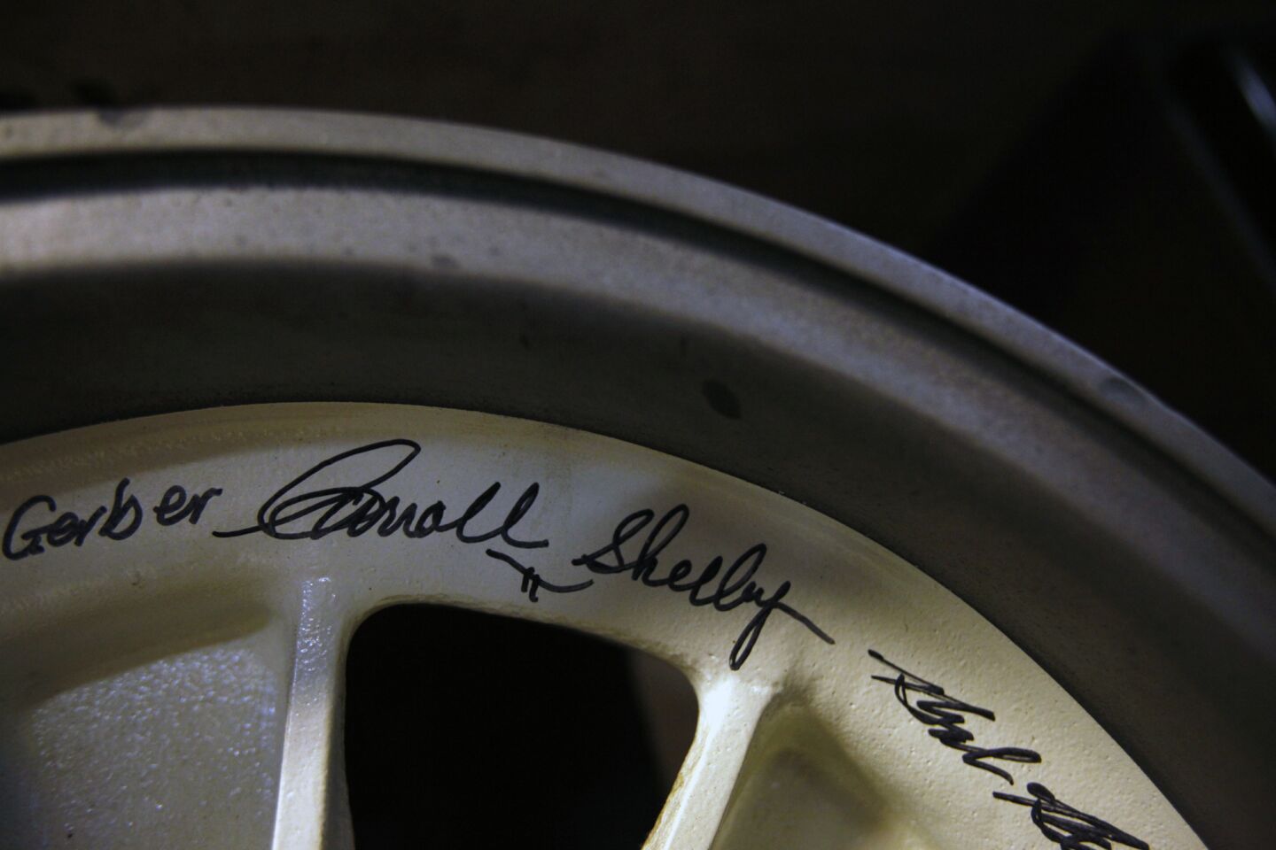 A racing rim signed by Carroll Shelby, the father of the Cobra, in Lynn Park's garage.