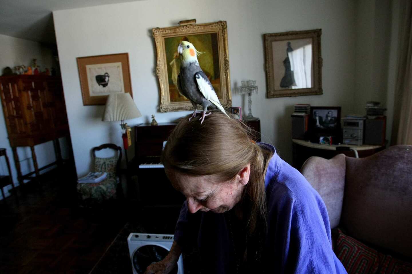 Patricia Morison, 97, with cockatiel Cookie, has lived at Park La Brea for more than 50 years. Back when, "It was more homogenous.... Most of the population was actors, actresses, artistic folks and businesspeople," she says. "There were never any children." About its evolution over the decades, she's philosophical: "Life goes, life changes."