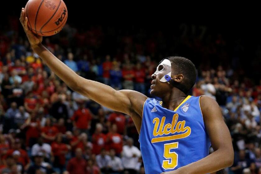 The man in the mask, UCLA forward Kevon Looney, shoots a layup against Arizona in the Pac-12 Conference tournament semifinals.