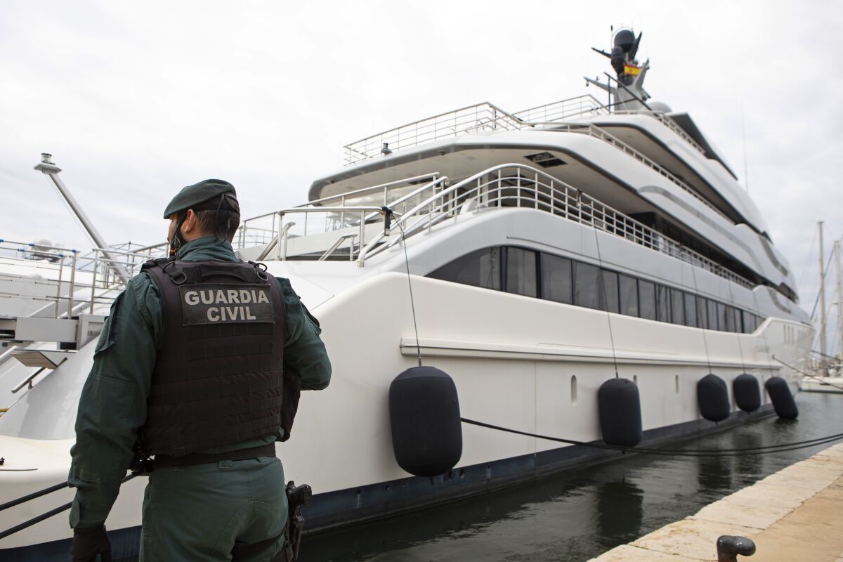 Spanish Civil Guard member standing by a yacht