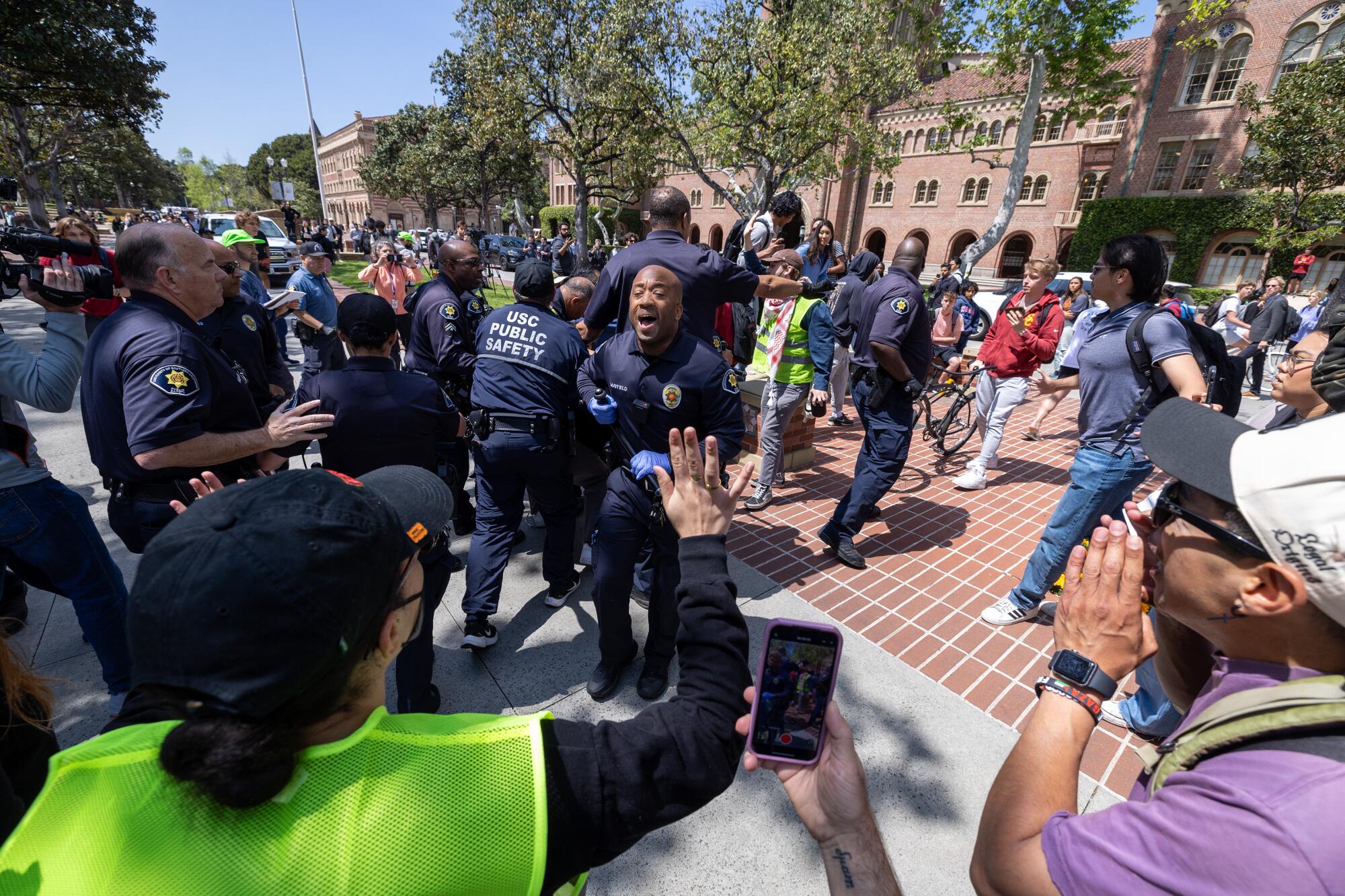 Public safety officers confront student protesters