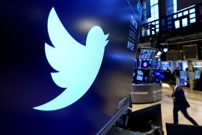 FILE - The logo for Twitter appears above a trading post on the floor of the New York Stock Exchange, Monday, Nov. 29, 2021. Elon Musk is taking a 9.2% stake in Twitter. Musk purchased approximately 73.5 million shares, according to a regulatory filing. (AP Photo/Richard Drew, File)