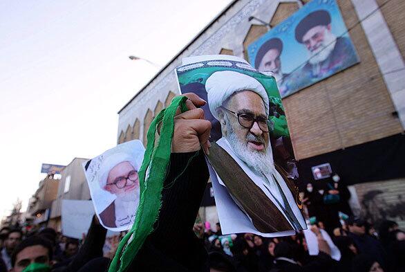 Pro-reformists hold up portraits of Montazeri during his funeral procession. He was carried from his home in Qom to the shrine of of Fatemeh Masoumeh, where he was laid to rest.