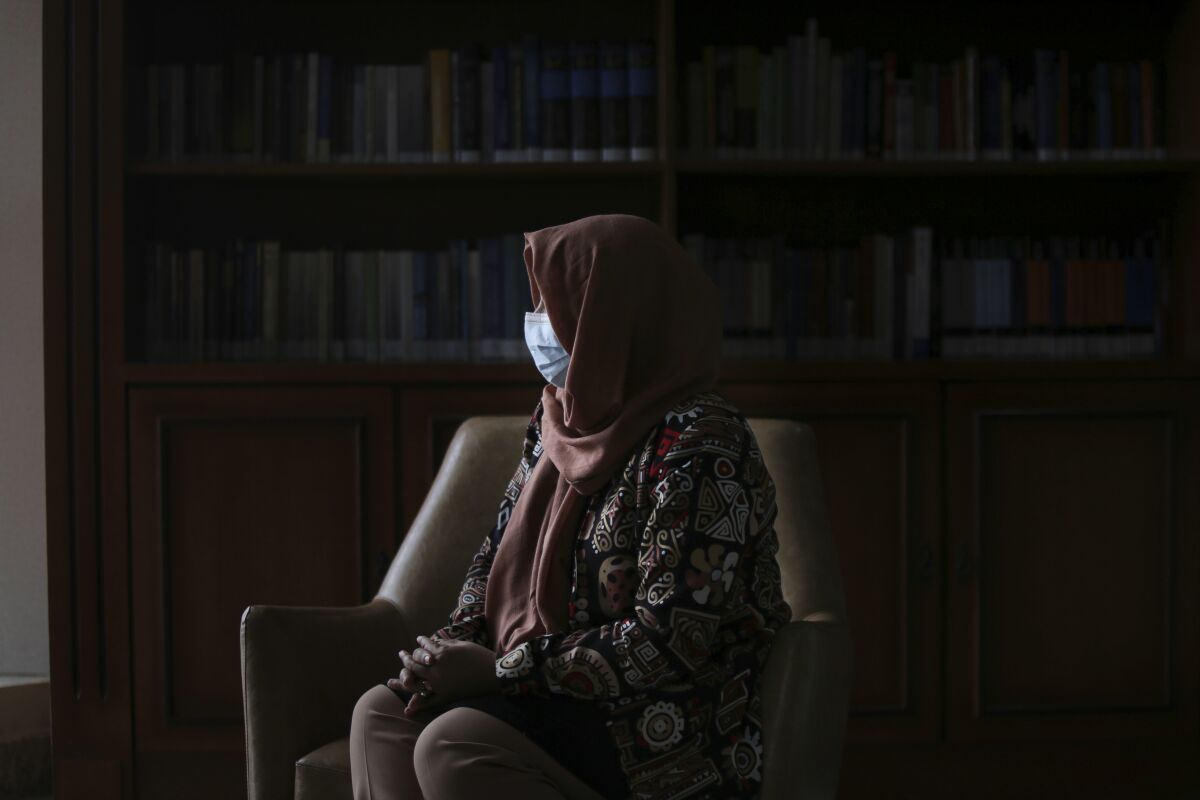 An Afghan judge who asked that her true name not be used, sits during an interview with The Associated Press in Brasilia, Brazil, Wednesday, Dec. 1, 2021. Seven Afghan female judges have taken refuge in Brazil due to fears of retribution from the Taliban. (AP Photo/Raul Spinasse)