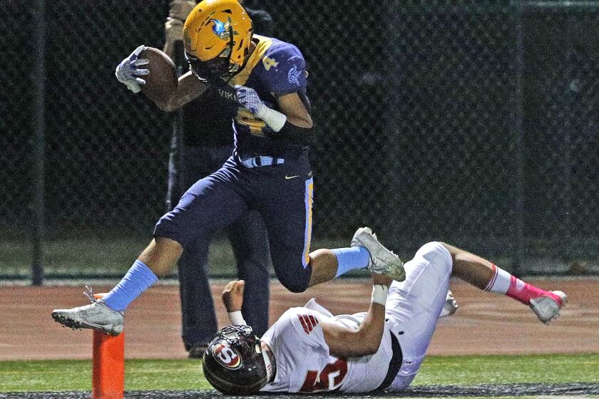 Marina's Pharoah Rush jumps to keep from being tackled by Segerstrom's Saul Ramirez to score the first touchdown of the game in a Big 4 League football game at Westminster High School on Thursday, October 15, 2019.