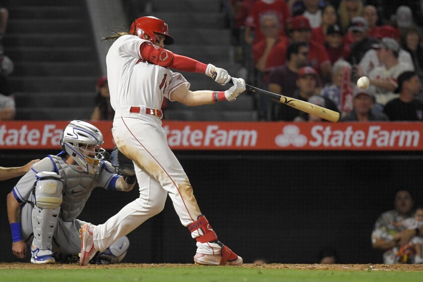 The Angels' Brandon Marsh connects for a sixth-inning solo homer June 10, 2022. Mets catcher Tomas Nido is at left.