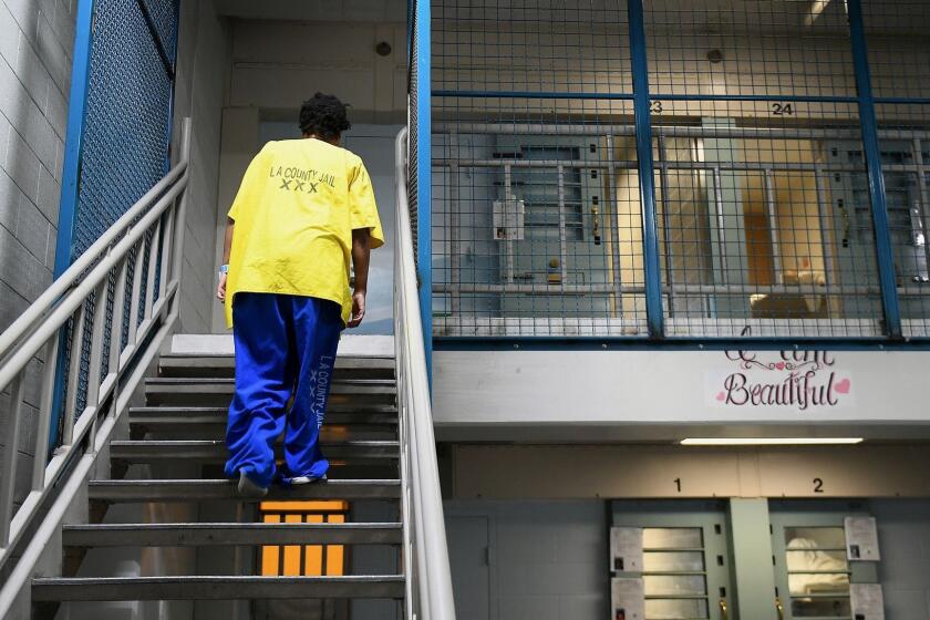 LOS ANGELES, CA-OCTOBER 2, 2017: An inmate inside Century Regional Detention Facility in Los Angeles heads towards her upstairs cell on Monday, October 2, 2017. The jail, which houses female inmates, is where two alleged rapes by a male guard happened earlier this month. The alleged assaults came at a time when the Los Angeles County Sheriff's Department, which runs the jail, is trying to implement changes to ensure the sexual safety of inmates and become compliant with a federal mandate to eliminate prison rape. (Christina House / Los Angeles Times)