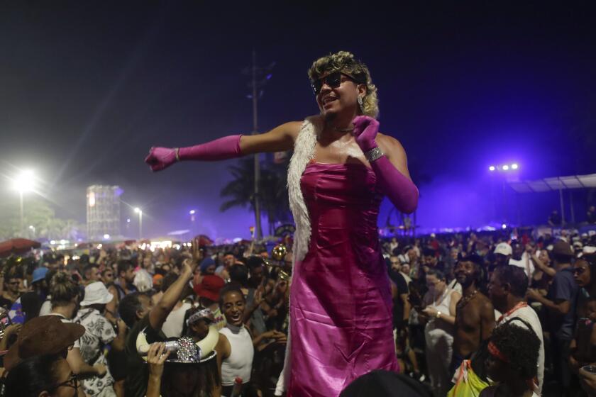 A fan dances while waiting for the start of Madonna's last show of her The Celebration Tour, on Copacabana beach in Rio de Janeiro, Brazil, Saturday, May 4, 2024. (AP Photo/Bruna Prado)
