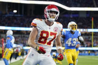 Kansas City Chiefs tight end Travis Kelce celebrates his touchdown as Los Angeles Chargers cornerback Michael Davis, right, stands in the background during the second half of an NFL football game Sunday, Nov. 20, 2022, in Inglewood, Calif. (AP Photo/Jae C. Hong)
