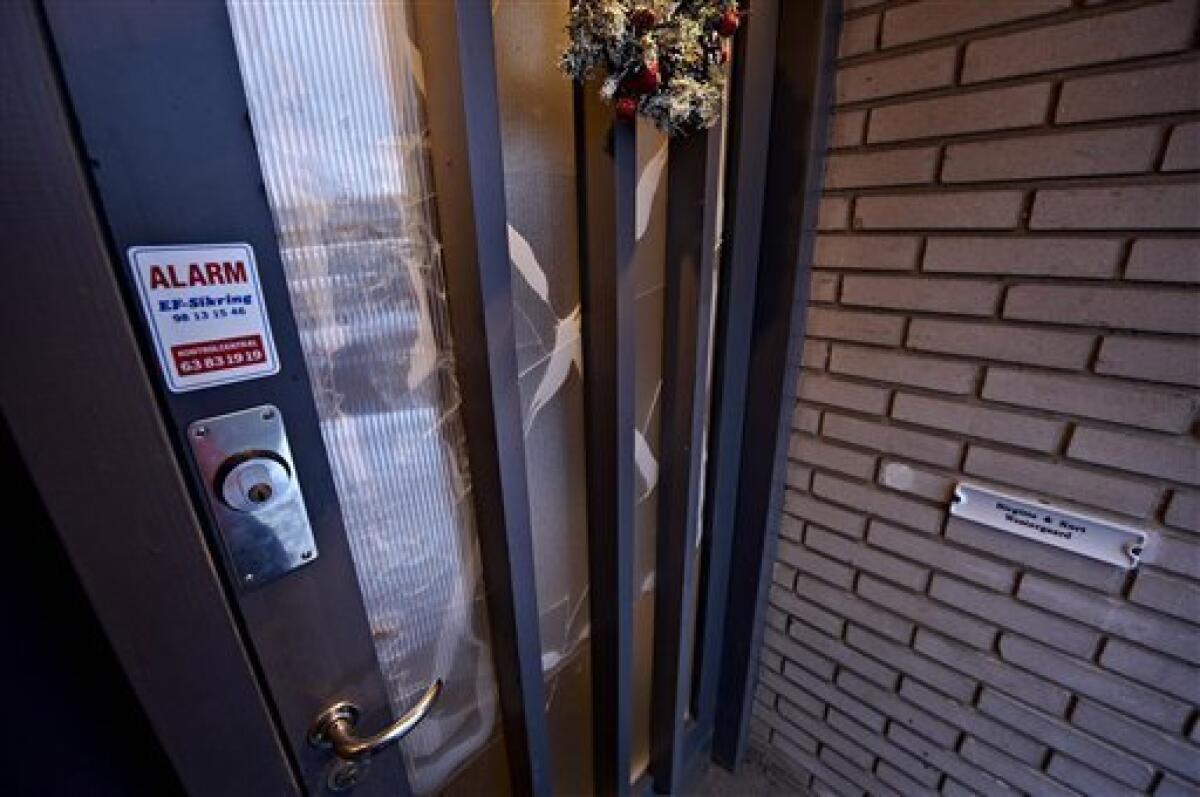 The damaged front door of Danish cartoonist Kurt Westergaard's home is seen in Aarhus, Denmark, Saturday, Jan. 2, 2010. Police shot a Somali man wielding an ax and a knife after he broke into the home of an artist whose cartoon of the Prophet Muhammad with a bomb-shaped turban outraged the Muslim world, the head of Denmark's intelligence agency said Saturday. (AP Photo/Polfoto, Ernst van Norde) DENMARK OUT