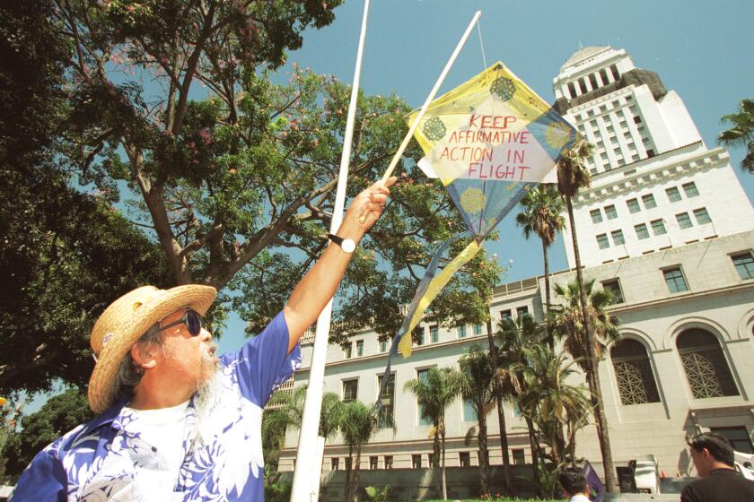 ME.Asian.#3.0910.RM/c L to R. Roy Morales flyes a kite that says "Keep Affirmative Action in Flight. The Asian Pacific Policy and Planning Council sponsored this unity and issues rally. Event was held today on the south steps of LA City Hall. About 300 people attended. TUE FOLDER Rick Meyer/LATMandatory Credit : Rick Meyer/The LA Times