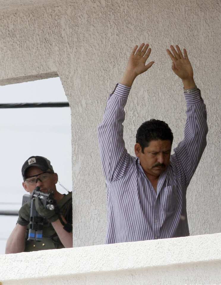 Cudahy City Councilman Osvaldo Conde surrenders to the FBI after a standoff at his business.