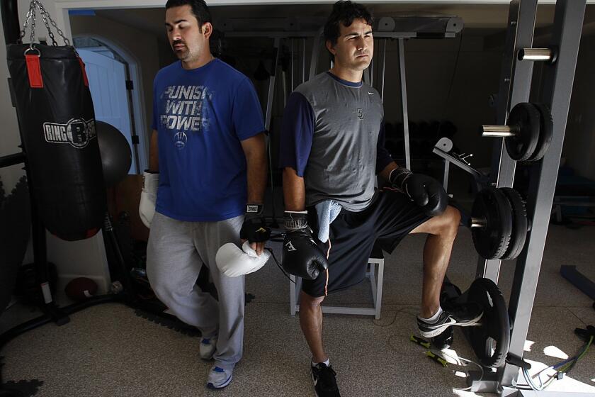 Dodgers first baseman Adrian Gonzalez, left, works out with brother Edgar in La Jolla, his offseason home.