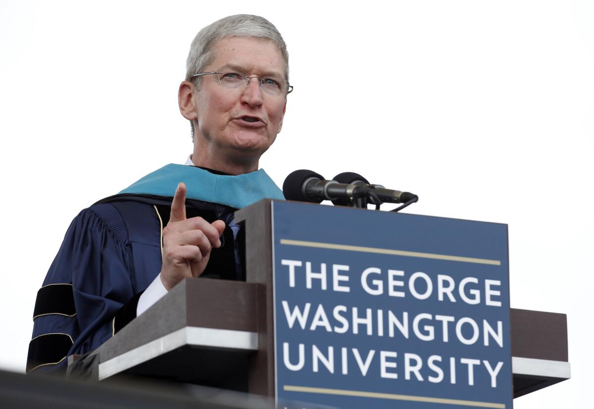 Apple CEO Tim Cook speaks to graduates during George Washington University's commencement exercises on the National Mall.