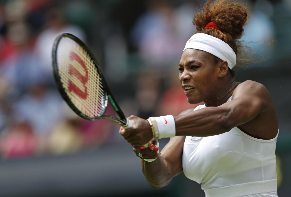 Serena Williams returns a shot during her first-round victory over Mandy Minella at Wimbledon on Tuesday.