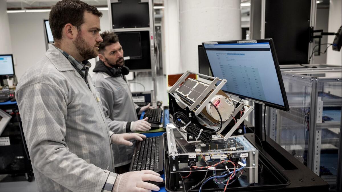 Engineer Brent Amiano runs tests on a satellite at Planet's manufacturing and testing facilities in San Francisco.