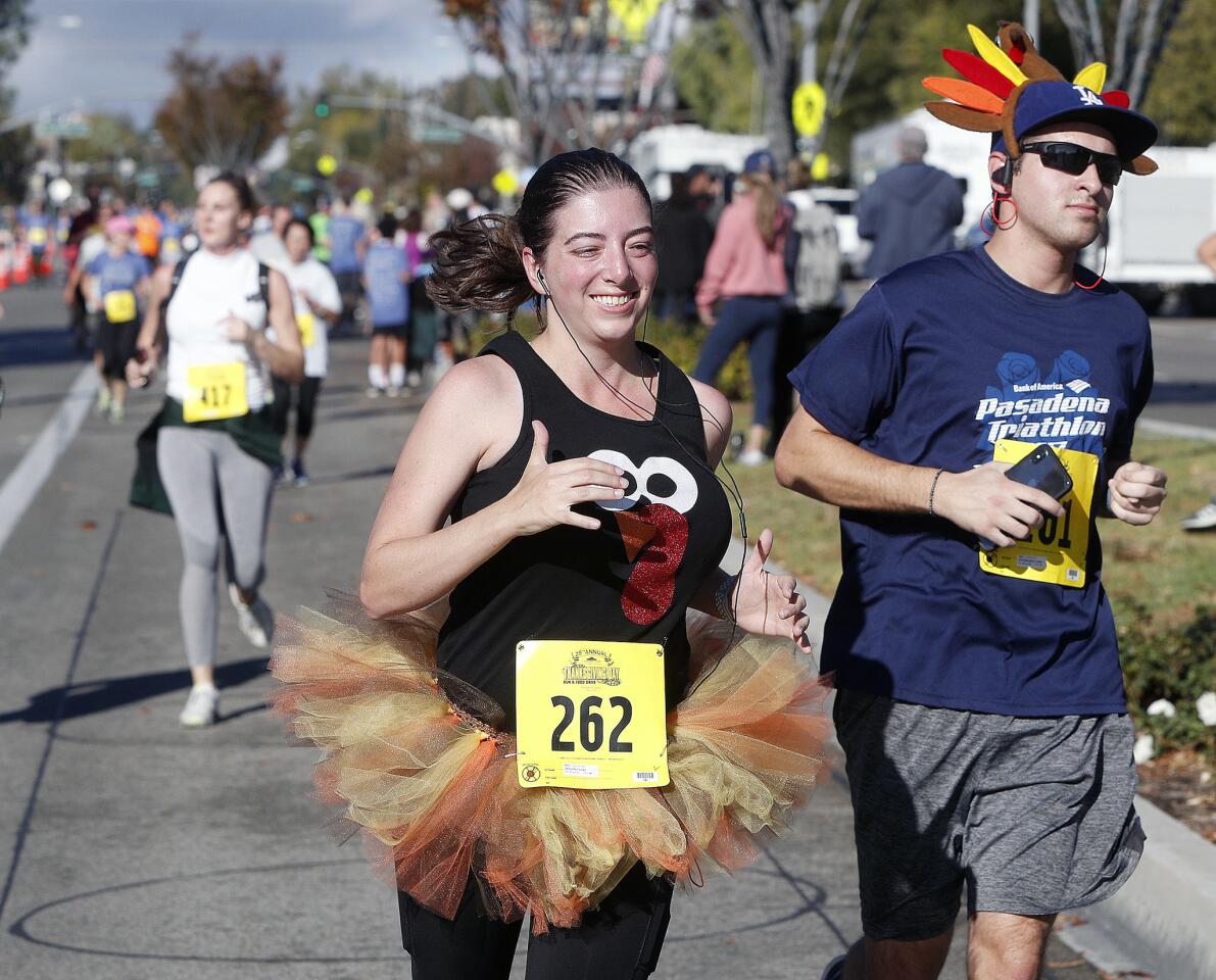 Siblings Jennifer and Chris Lazo, of La Canada, run to the 5k finish at the 25th annual Thanksgiving Day Run & Food Drive near Memorial Park in La Canada Flintridge on Thursday, November 22, 2018. The Community Center of La CaÃ±ada Flintridge sponsors the run which includes a 5k and a 1-mile kids run with a total number of runners at about 1,245.