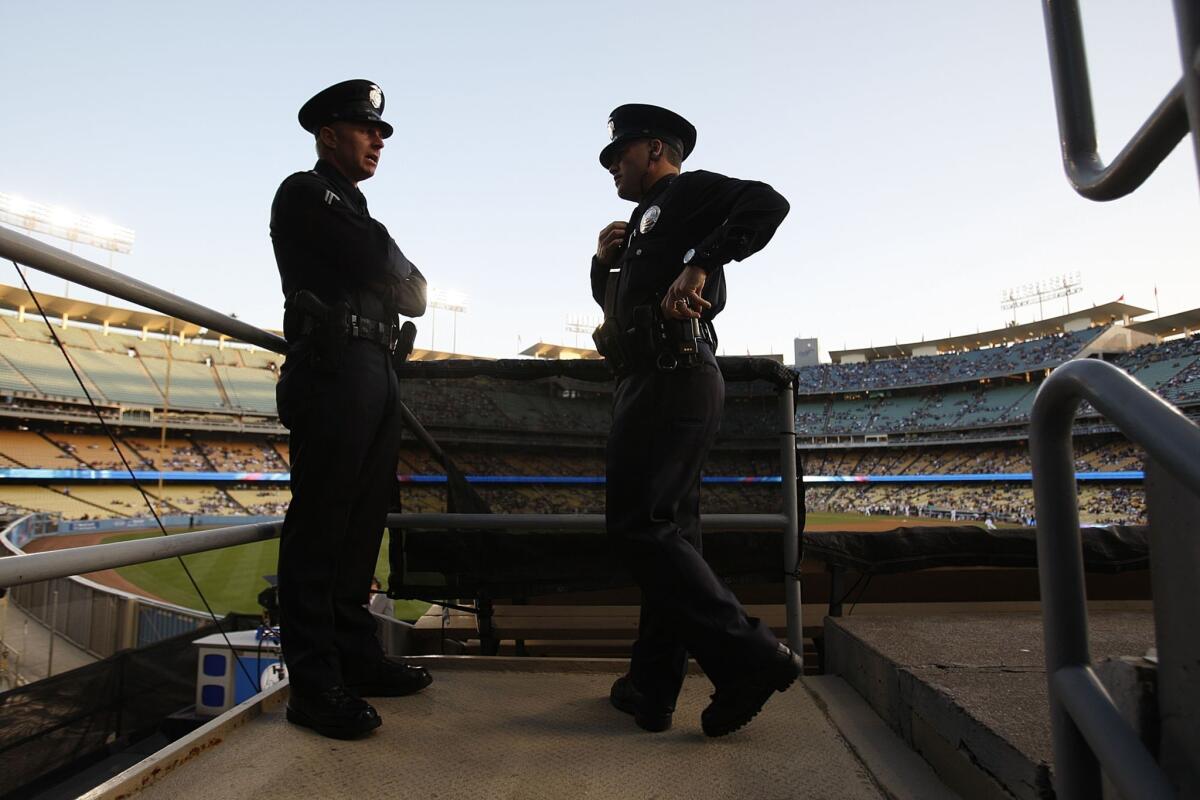 Los Angeles Police officers at Dodger Stadium in 2011. A gift from the team boosts a plan to equip LAPD patrols with on-body cameras.