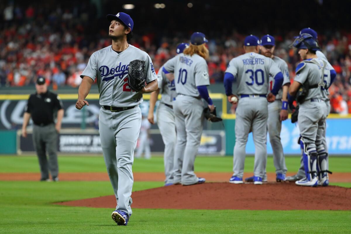 Dodgers pitcher Yu Darvish walks off the field after being taken out of the game in the second inning.