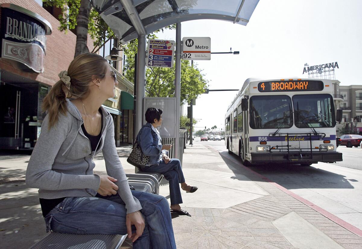 In this September 2009 photo, Tamara Kulik, 23 of Glendale, waits for the Number 2 Beeline bus on Brand Blvd. at Harvard St. in Glendale. The City Council voted Tuesday to have an outside firm analyze parking data, Glendale Beeline ridership and count how many cars are rolling through intersections as well as the number of bicyclists.