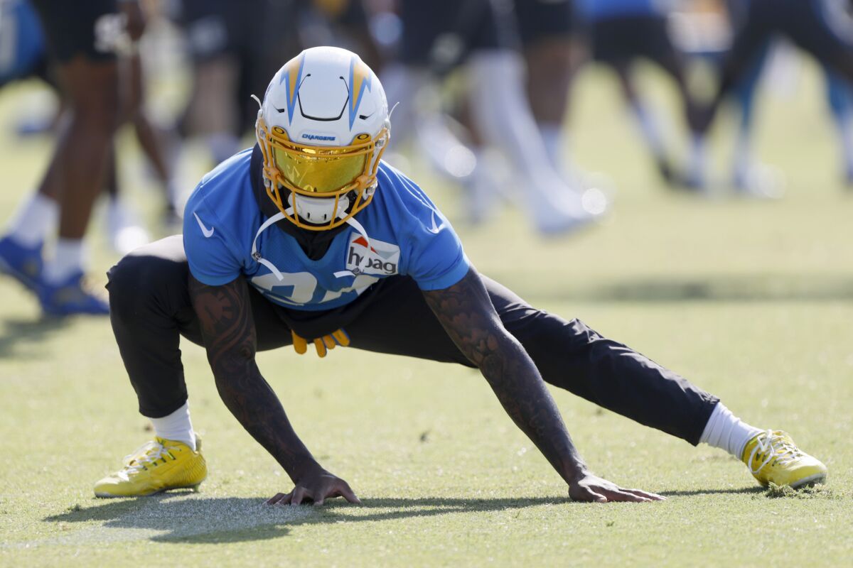 Chargers safety Nasir Adderley stretches.