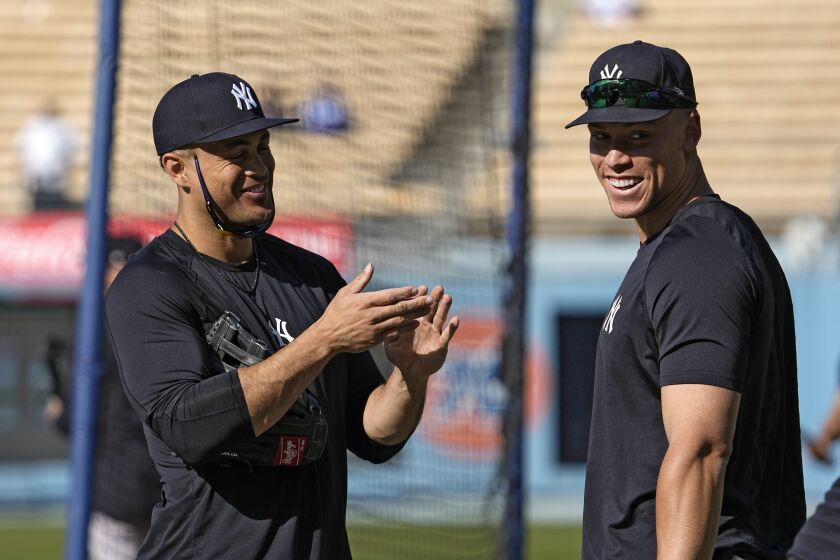 New York Yankees' Giancarlo Stanton, left, and Aaron Judge talk as they warm up prior to a baseball game against the Los Angeles Dodgers Friday, June 2, 2023, in Los Angeles. (AP Photo/Mark J. Terrill)