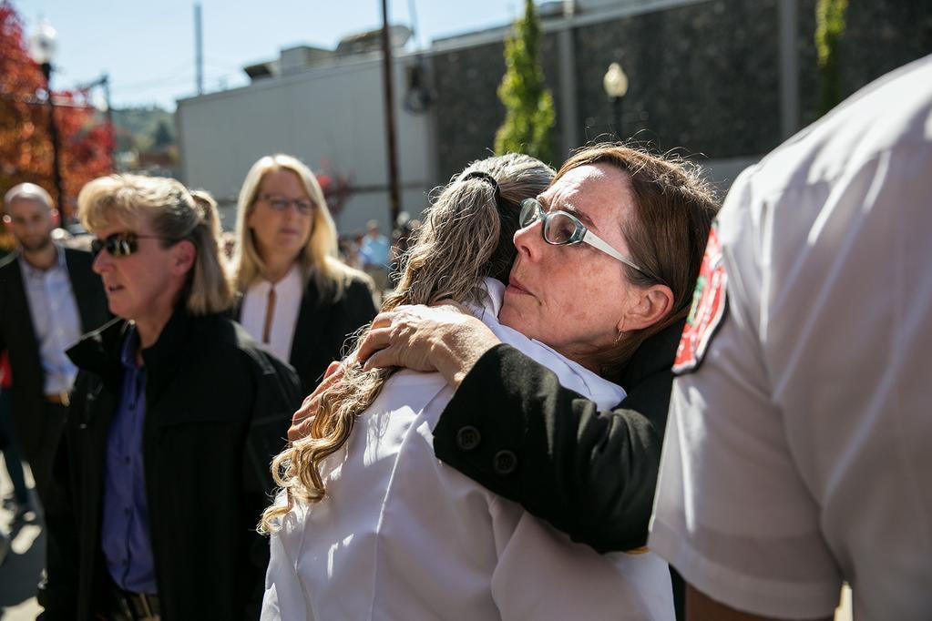 After an emotional press conference, Oregon Gov. Kate Brown hugs first responders.
