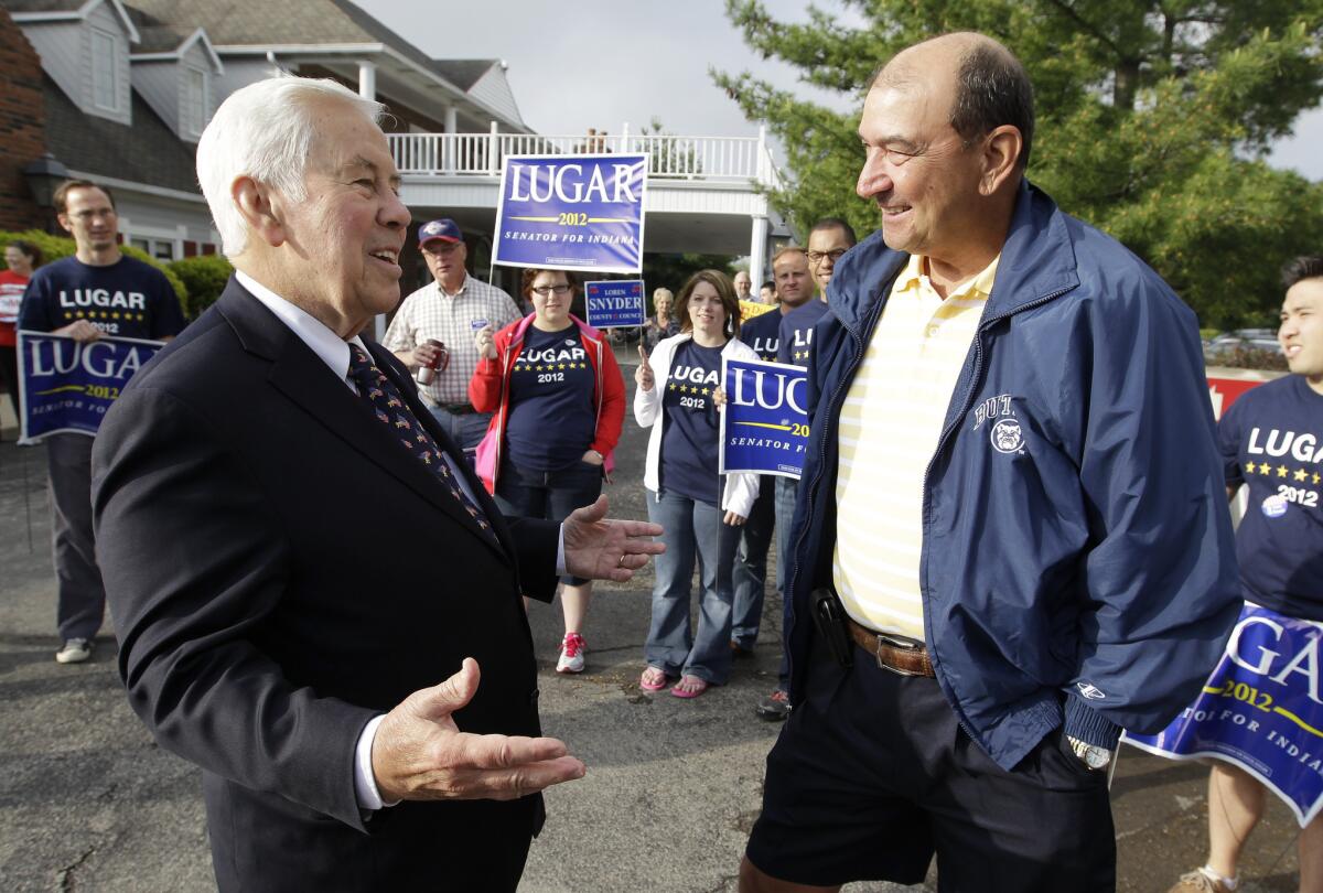Sen. Richard G. Lugar talks with Joe Purichia before voting in Greenwood, Ind.