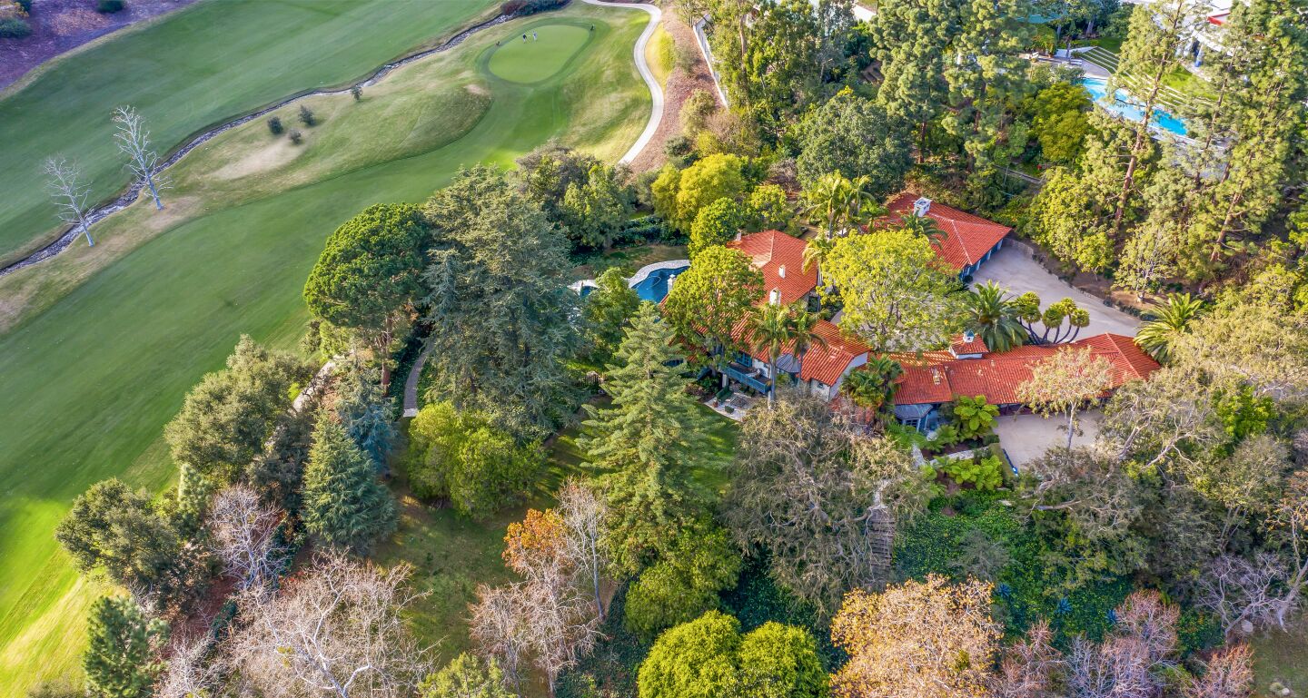 An aerial view of the home bordering the golf course.