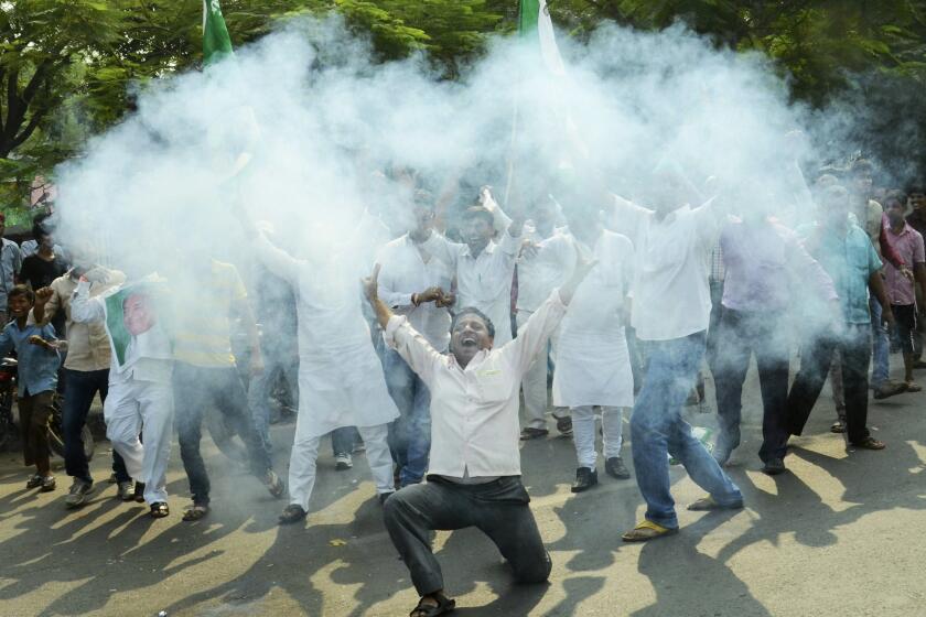 Supporters of an alliance of parties opposed to India’s ruling Bharatiya Janata Party light firecrackers to celebrate as early results of Bihar state elections indicate victory for them in Patna, India, on Sunday.