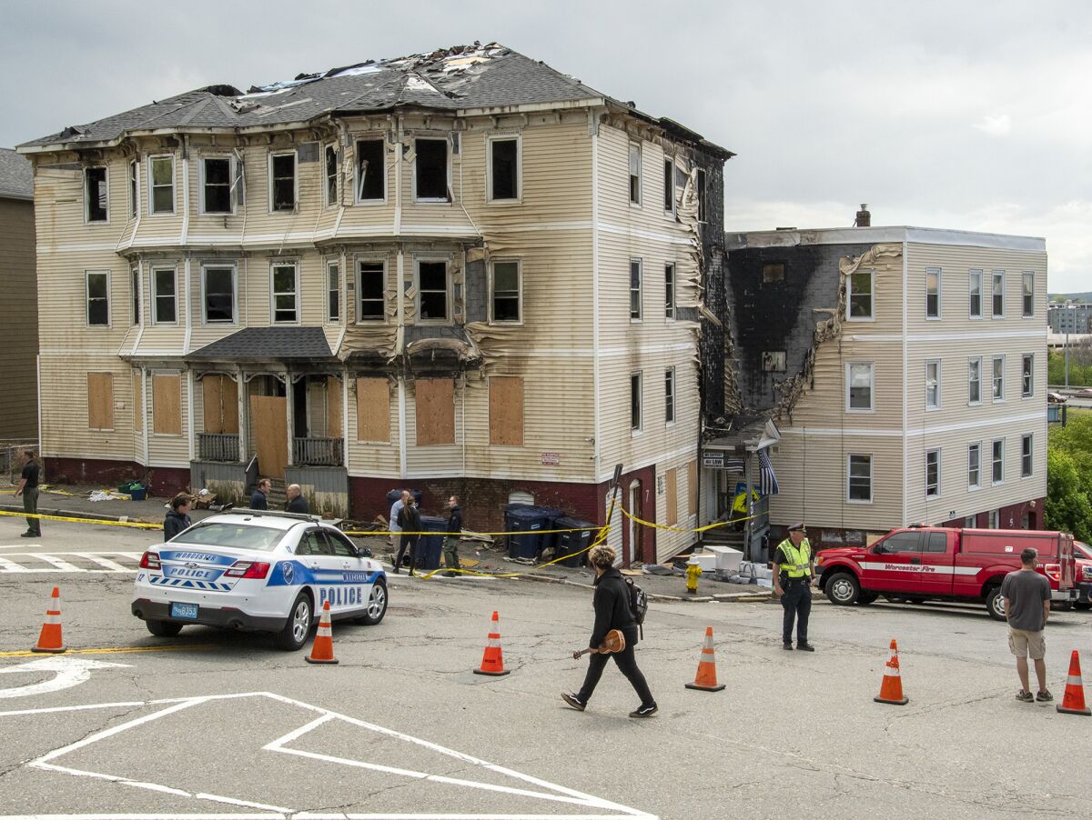 FILE - Officials investigate the scene of a fatal fire, Tuesday, May 17, 2022 in Worcester, Mass. One of the four people who died in a fire at a Massachusetts apartment building last weekend had filed a defamation lawsuit against right-wing radio host Alex Jones and his InfoWars website in 2018, alleging they falsely identified him as the gunman in a massacre at a Florida high school. A lawyer for 29-year-old Marcel Fontaine confirmed Thursday, May 19, that his client died in Saturday's fire in Worcester. (Rick Cinclair/Worcester Telegram & Gazette via AP)