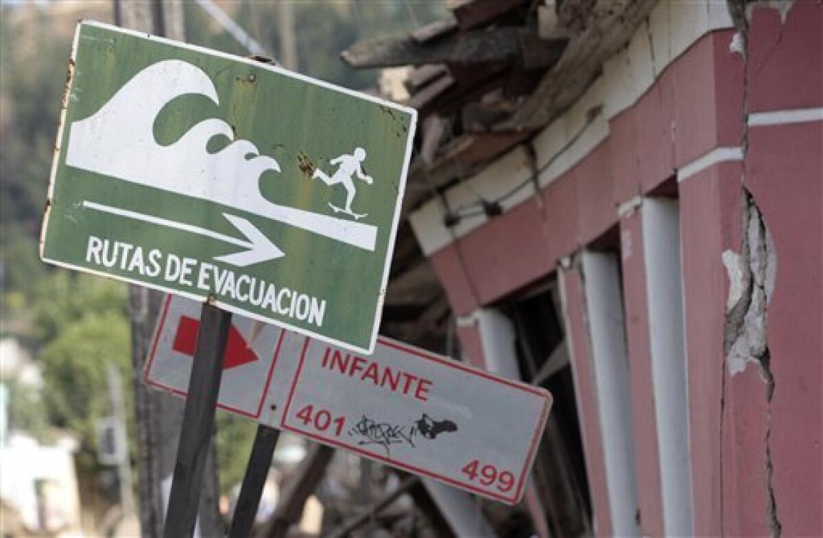 A sign reading in Spanish: "Evacuation Routes" is seen at at street in Constitucion, Chile, Tuesday, March 2, 2010. The 8.8-magnitude earthquake that struck central Chile early Saturday, Feb. 27, killed hundreds of people and caused widespread damage. (AP Photo/ Luis Hidalgo)