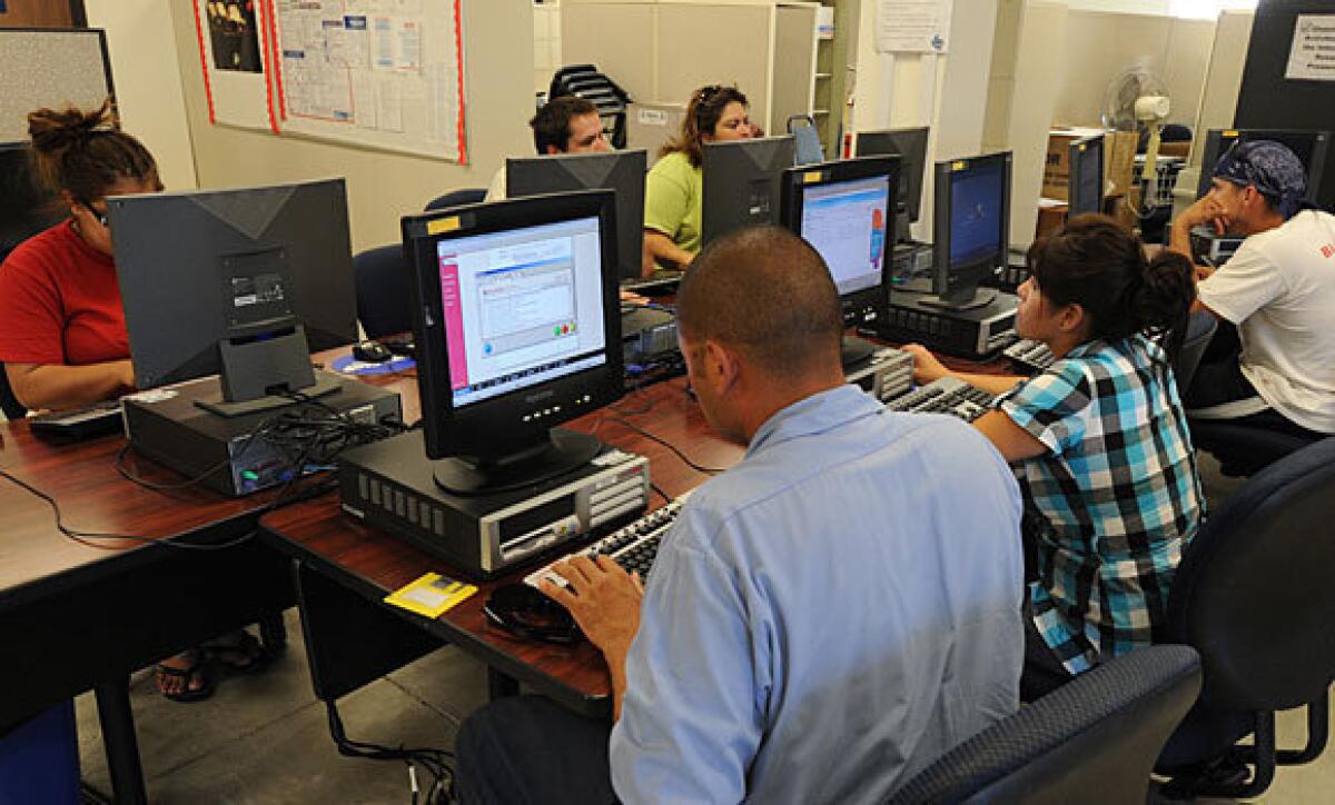 Job seekers at Rosemead center look for leads.