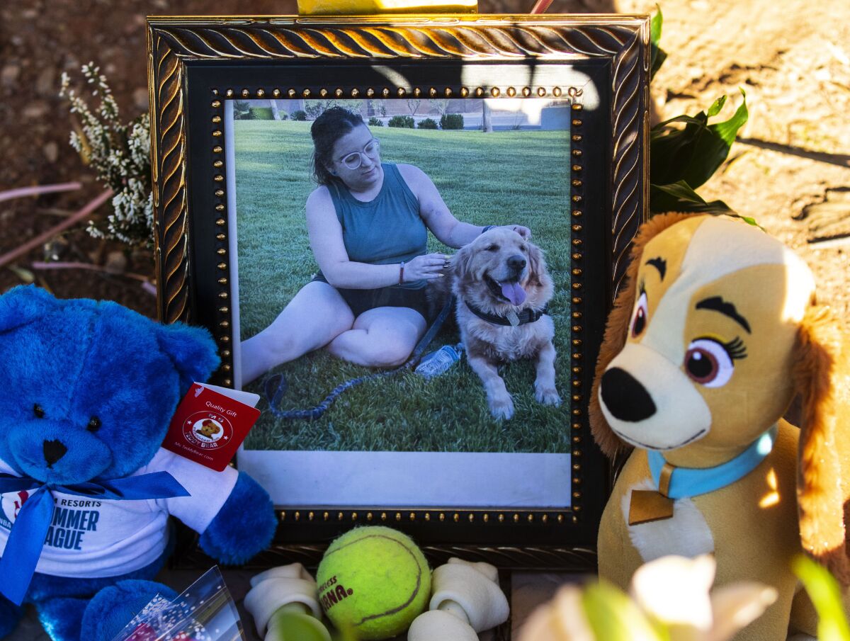 A photography of Tina Tintor, 23, and her dog is placed at a makeshift memorial site to honor them at South Rainbow Boulevard and Spring Valley Parkway, on Thursday, Nov. 4, 2021, in Las Vegas. Tintor and her dog were killed when Raiders wide receiver Henry Ruggs, accused of DUI, slammed into the rear of Tintor's vehicle. (Bizuayehu Tesfaye/Las Vegas Review-Journal)