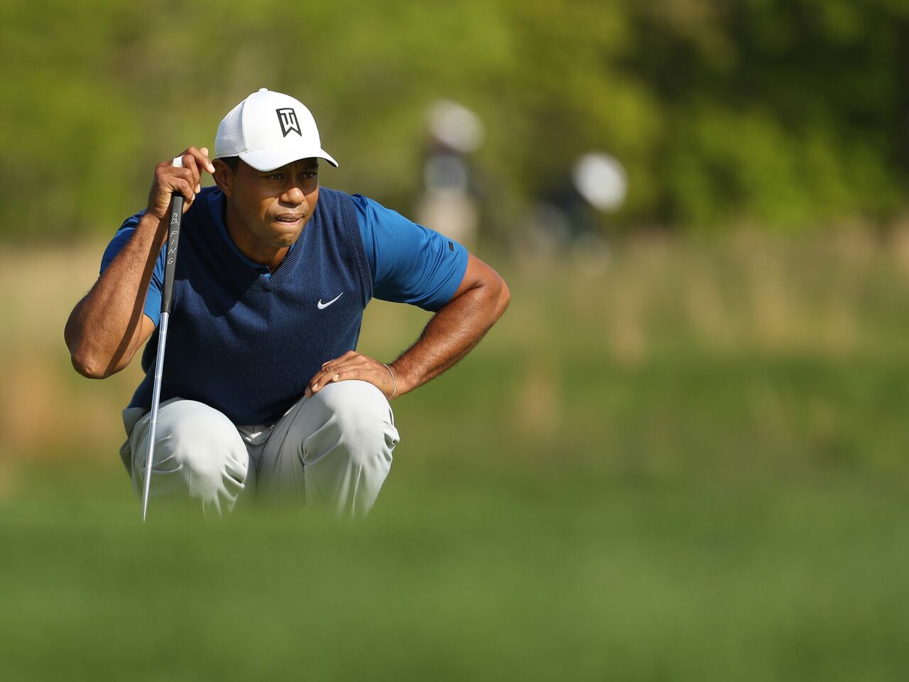 Tiger Woods lines up a putt on the 11th green during the first round of the 2019 PGA Championship at the Bethpage Black course in Farmingdale, N.Y.