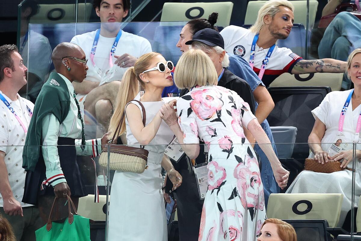 Recording artist Ariana Grande, left, and Vogue editor-in-chief Anna Wintour greet one another.